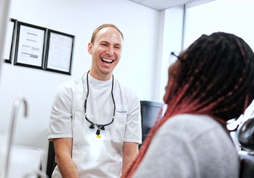 Dental professional laughing with patient