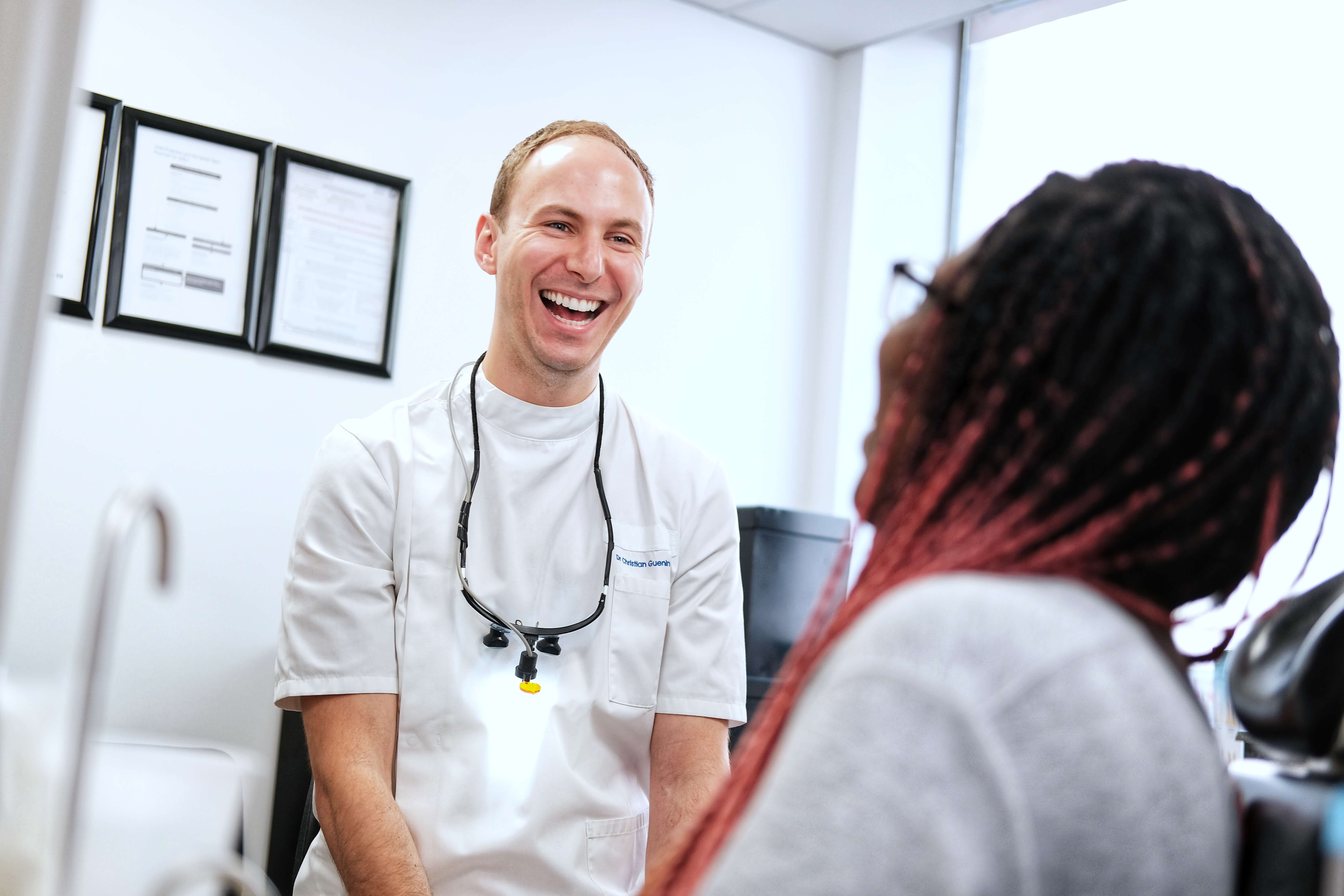 Dental professional laughing with patient