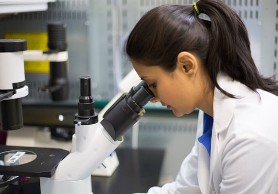 Technician with microscope