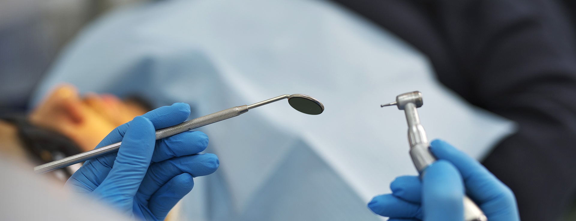 Photo of a dentist's hands holding instruments