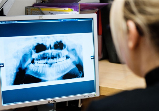 Dentist looking at x-ray