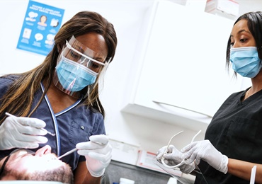 Dentist and nurse working on patient