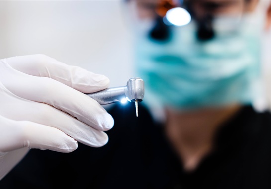 A dentist holding a drill.