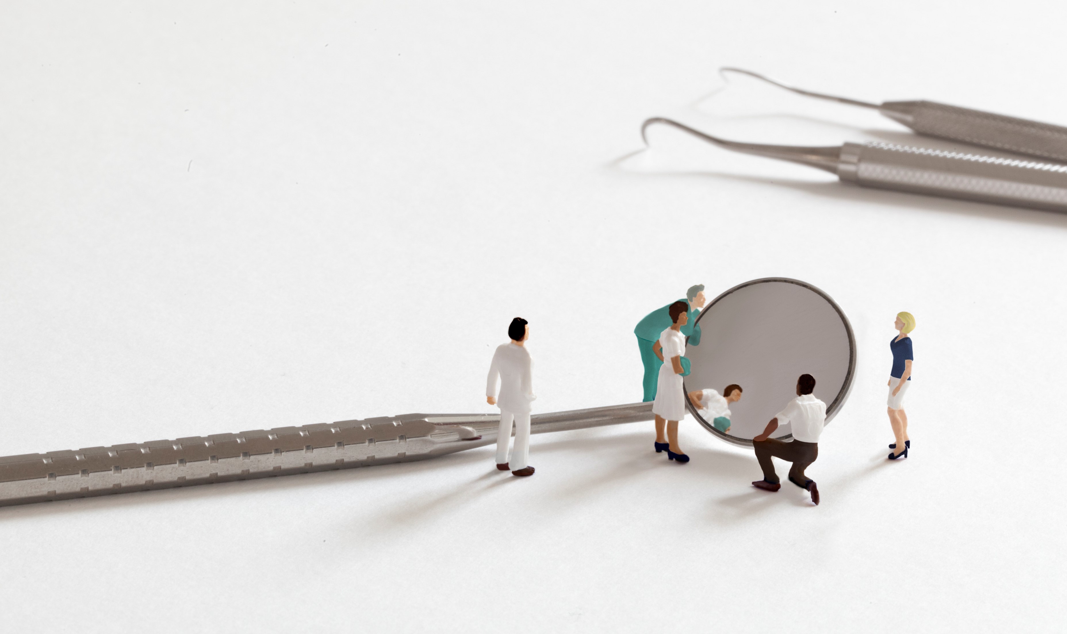 Reflective practice - 19003_GDC_reflection_st2_Background_image miniature people looking in dental mirror