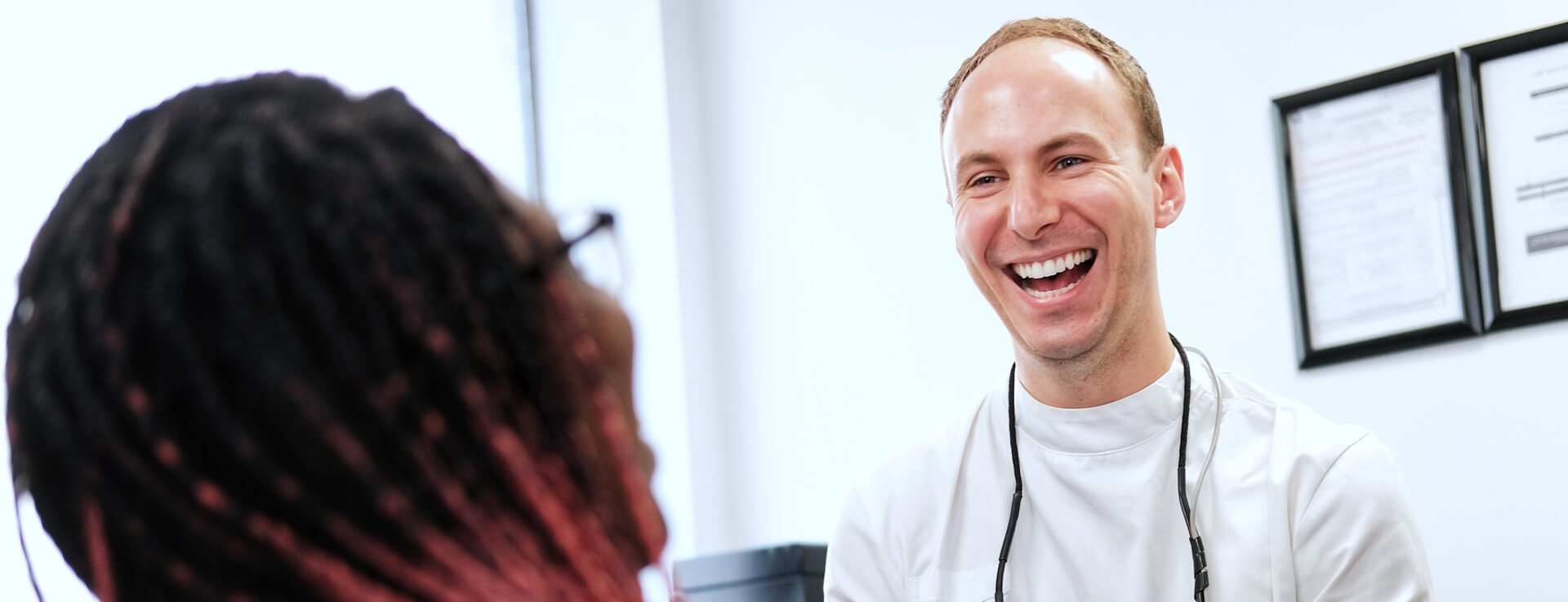 Dentist laughing with patient